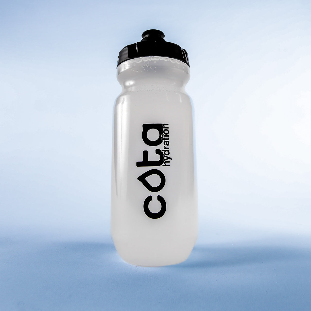 Cota Hydration clear water bottle on a light blue background