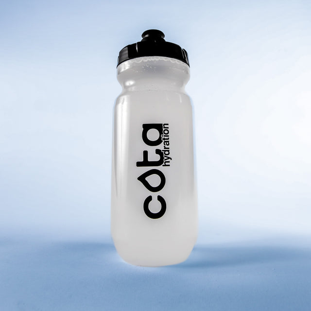 Cota Hydration clear water bottle on a light blue background